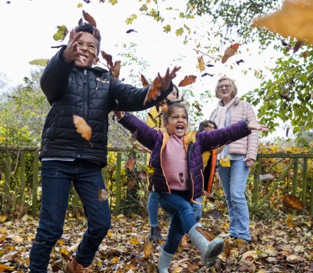 Children throwing leaves in the air